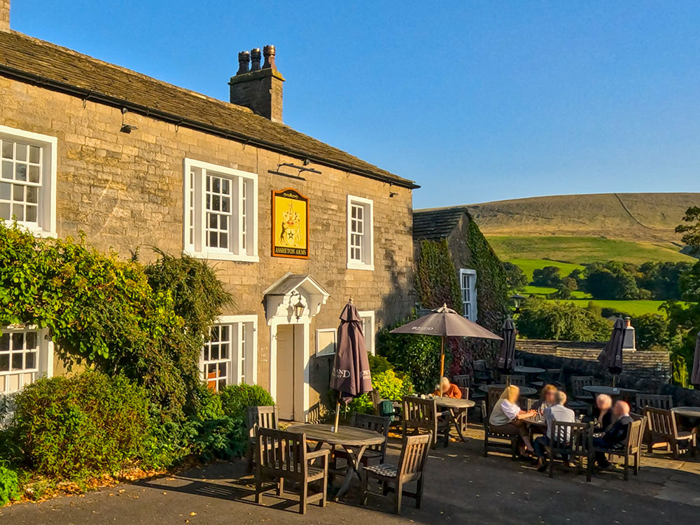 The Assheton Arms in Downham with Pendle Hill in the background