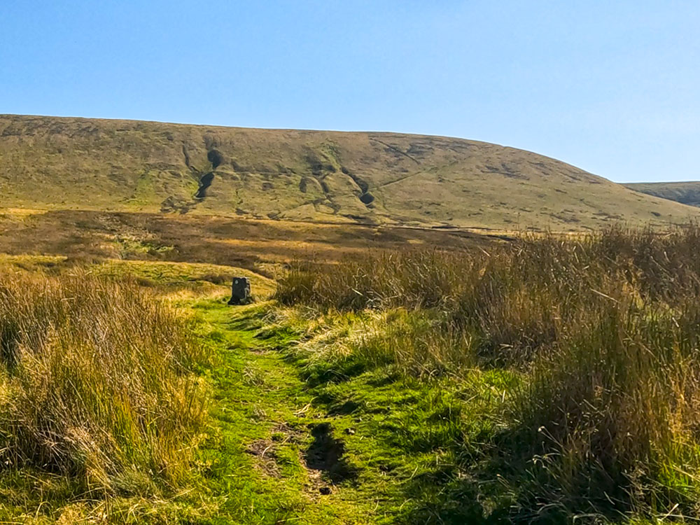 The path after Burst Clough, which can then be seen climbing diagonally up across Pendle Moor