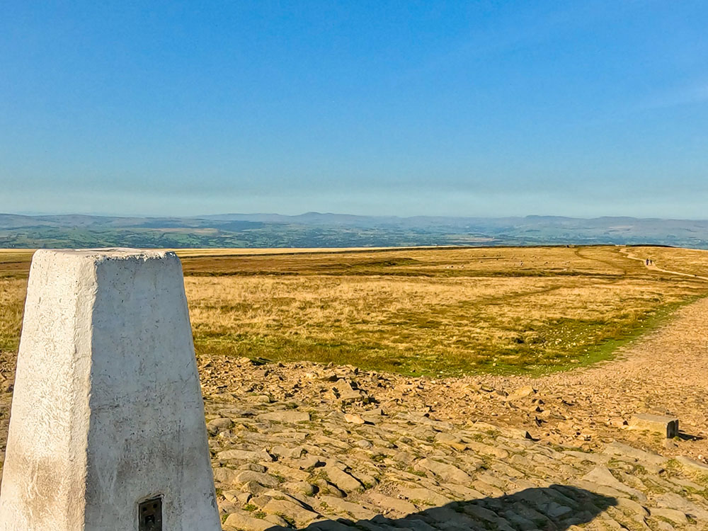 The view out towards the Yorkshire Dales from the trig point on the top of Pendle Hill