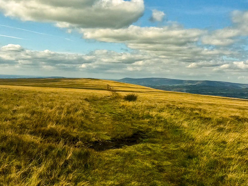 Heading north west along the wide grassy path away from the wall on the summit of Pendle Hill