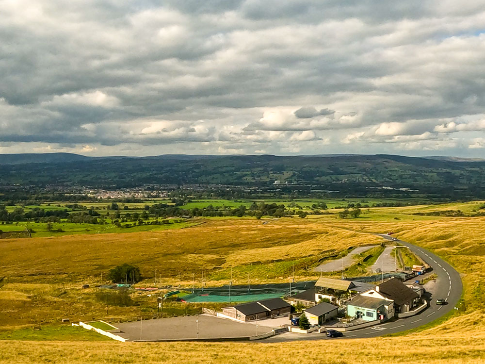 Looking back over the Wellsprings and the Pendle Ski Slope out over the Ribble Valley